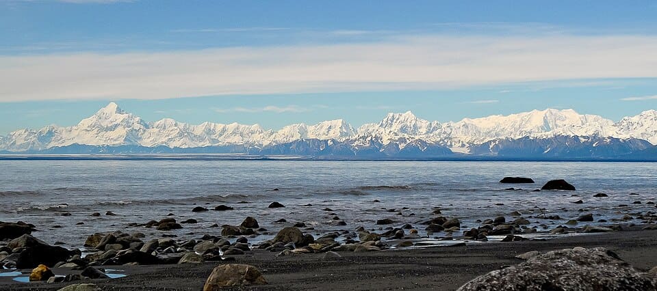 Snow-covered peaks of the Saint Elias Mountains viewed across a bay