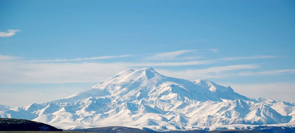 Mount Elbrus, Russia’s highest peak, with bright snow and blue sky in the background.