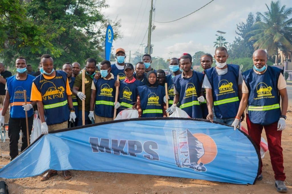 Members of the Mount Kilimanjaro Porters Society (MKPS) participating in the Moshi town clean-up organized by Zara Tanzania Adventures to promote environmental conservation.
