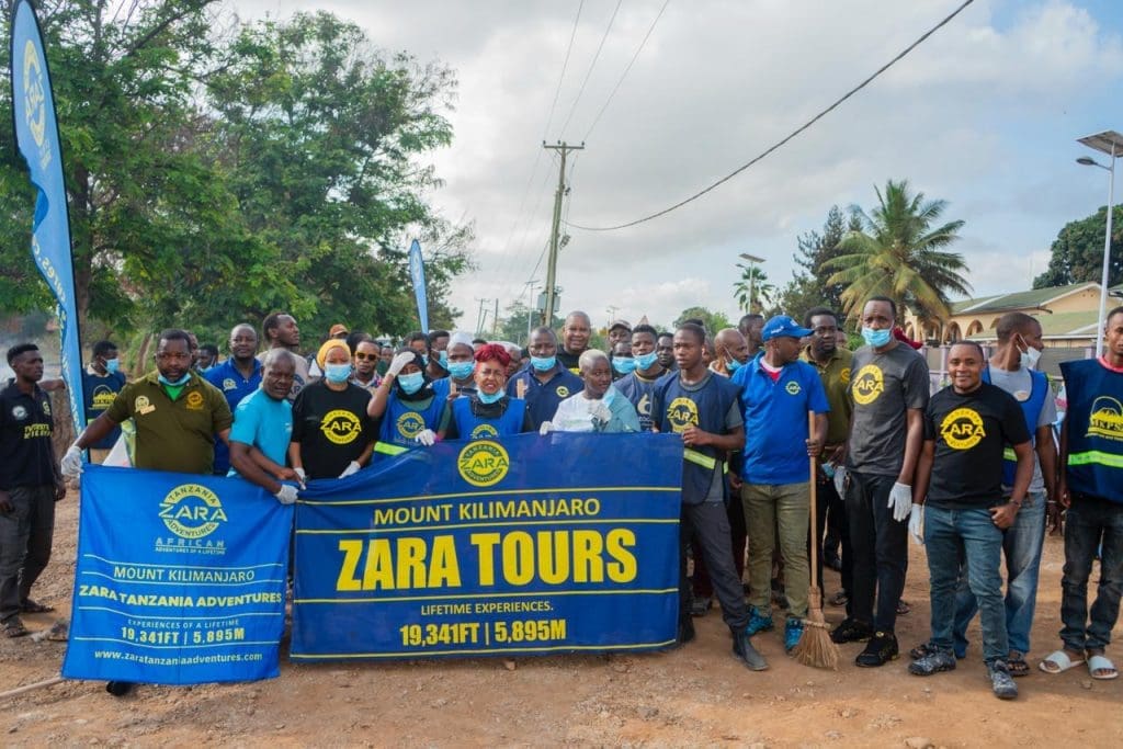 Zara Tanzania Adventures team and community members during a clean-up campaign in Moshi, promoting the “Green Tanzania Starts with Us” initiative.