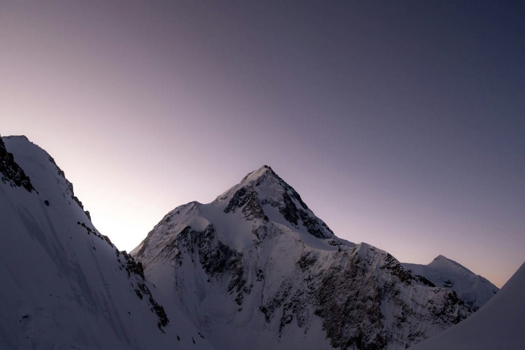 Gasherbrum I’s icy ridges illuminated by soft evening light.