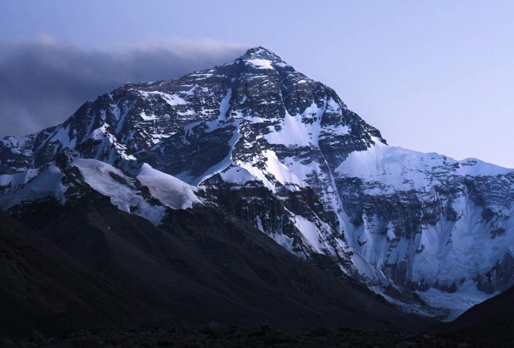 Snow-covered Mount Everest peak under a clear sky