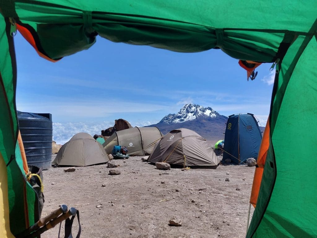 View of Mawenzi Peak framed from inside a tent at a high-altitude camp on the Rongai Route, Mount Kilimanjaro.