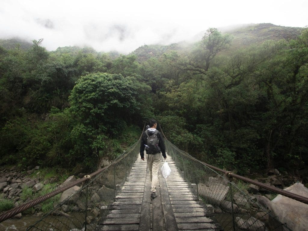 Hiker walking along a trail near Machu Picchu with mountain scenery in the Andes