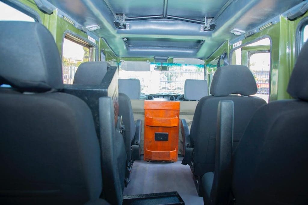 Interior of a 4x4 safari vehicle with comfortable seating and pop-up roof for wildlife viewing in Tanzania.